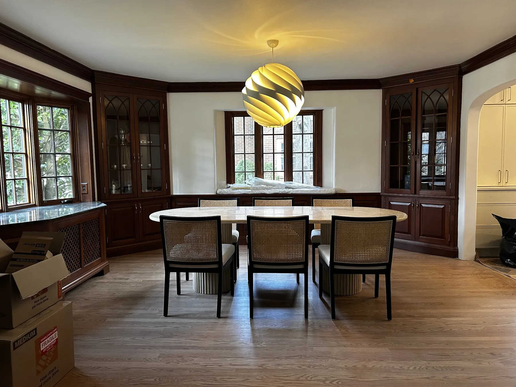 A wood-paneled room with a long table and chairs set out after a Planetary Movers move