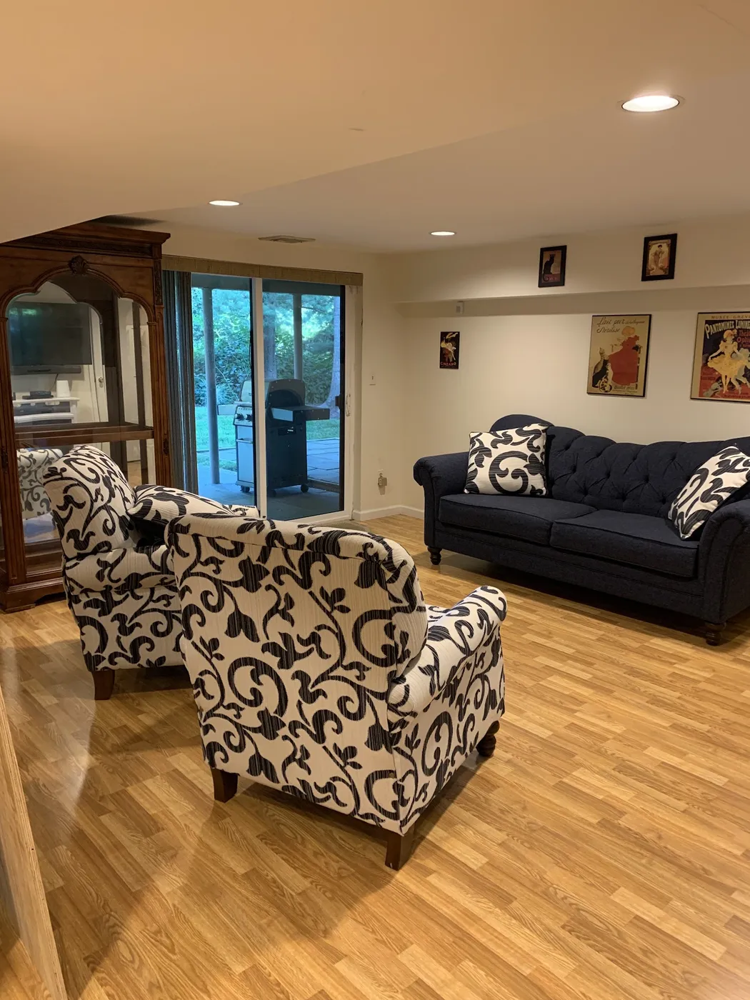 A living room with a sofa and patterned armchairs set in place after a move